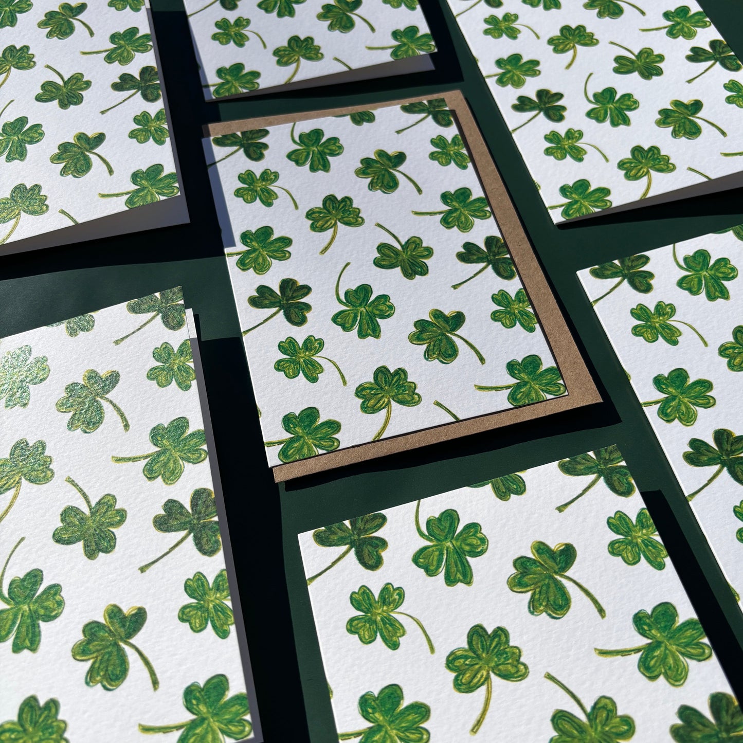 Multiple greeting cards with a green shamrock pattern