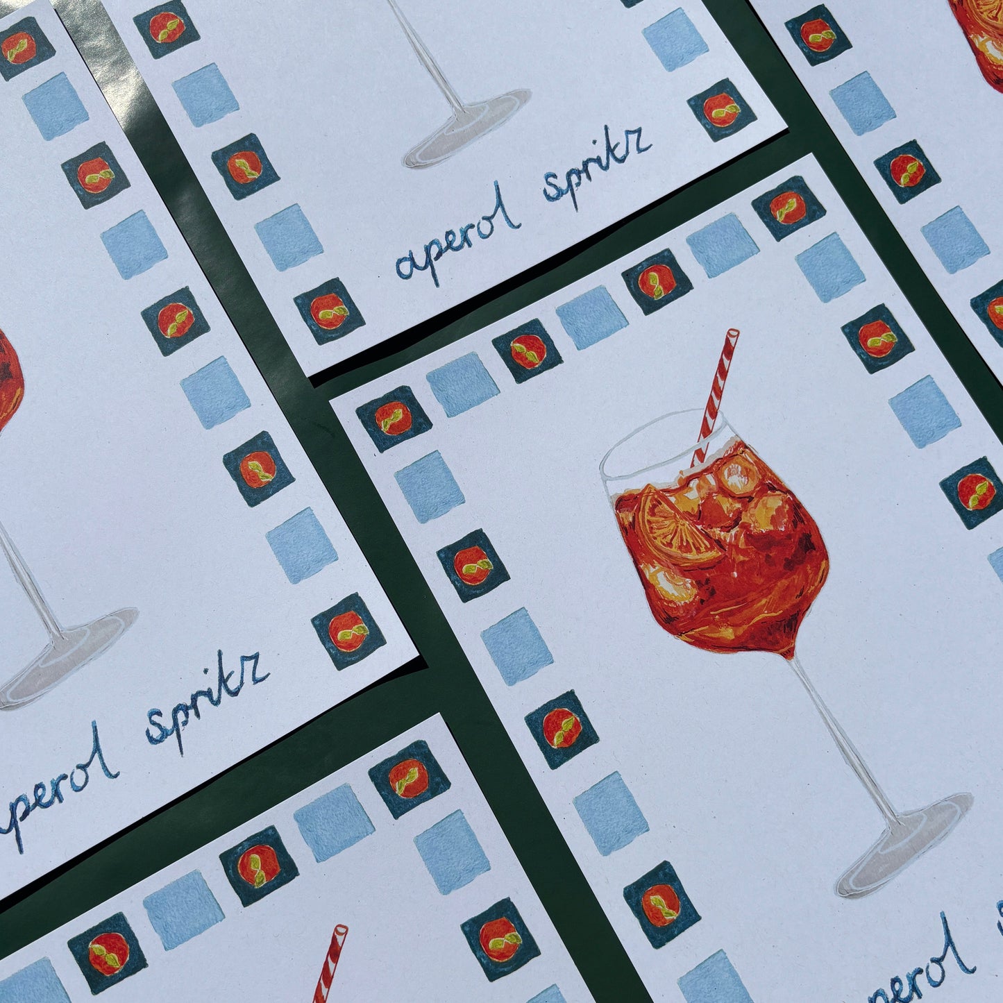 Prints with aperol spritz illustrations and text with a checkered border