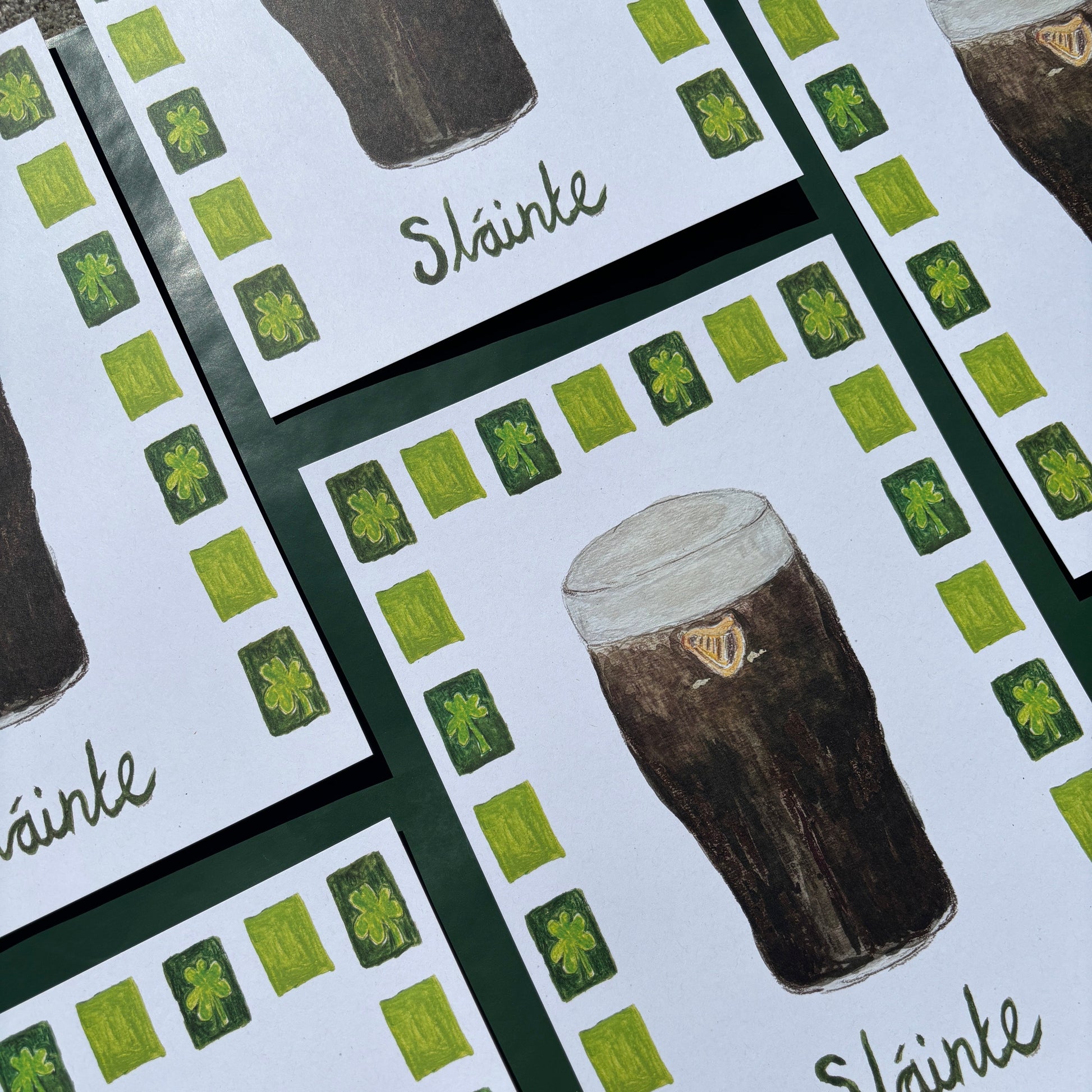 Set of prints with illustrated pints of Guinness with 'slainte' text