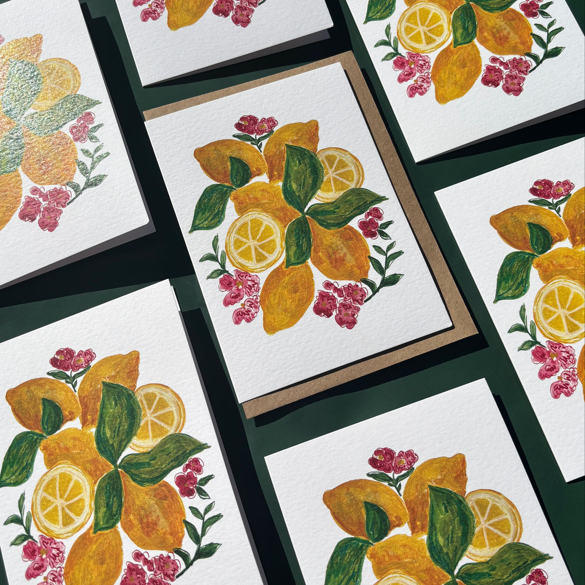 Multiple greeting cards with lemons and flower illustrations.