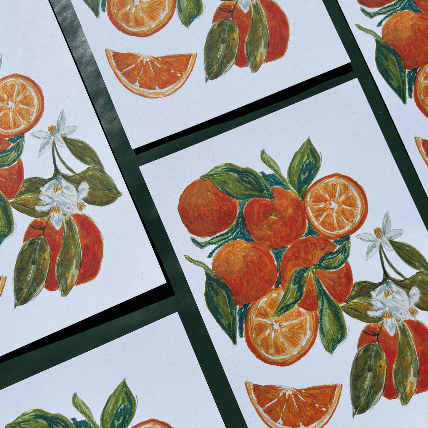 Multiple art prints with oranges and flower designs 