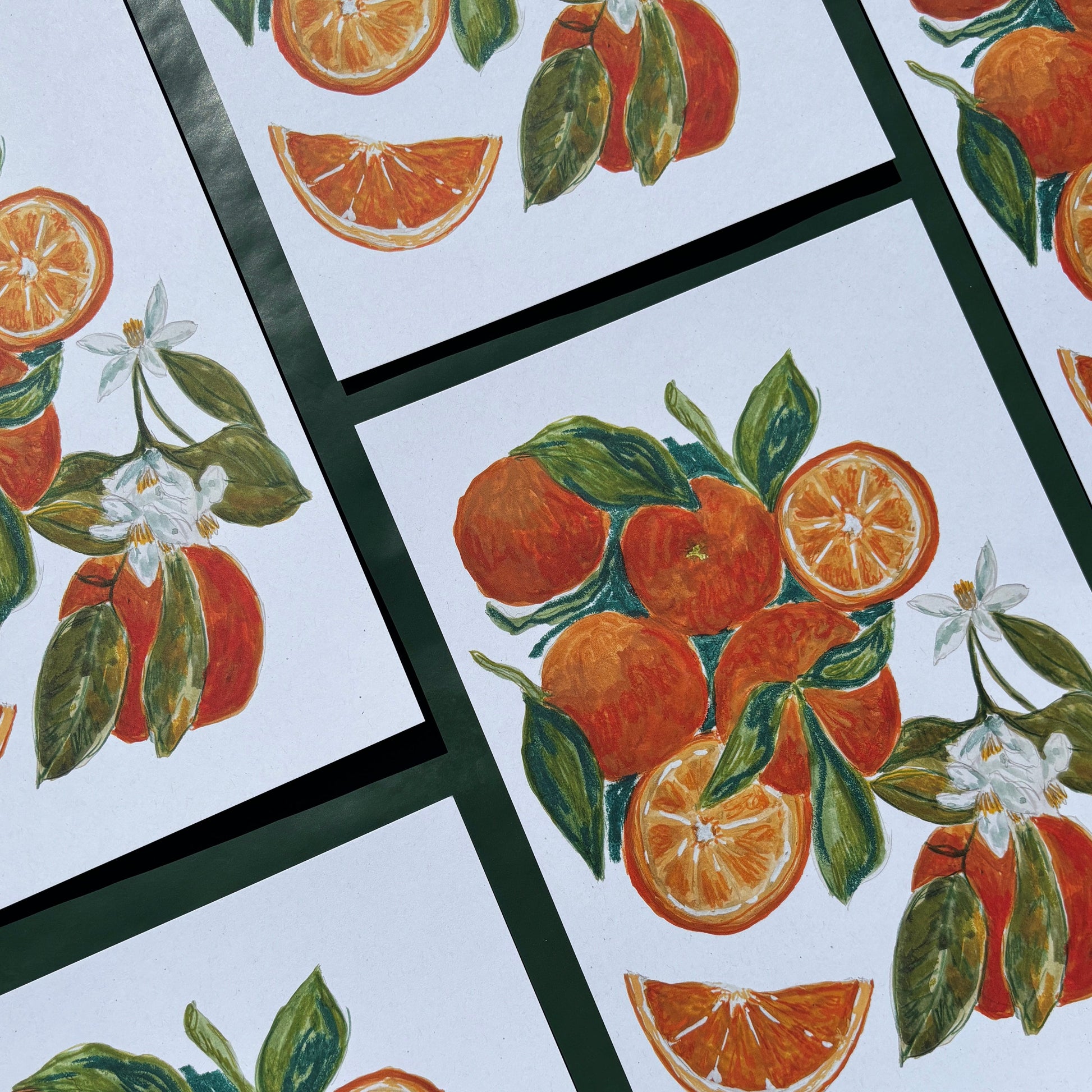 Multiple art prints with oranges and flower designs 