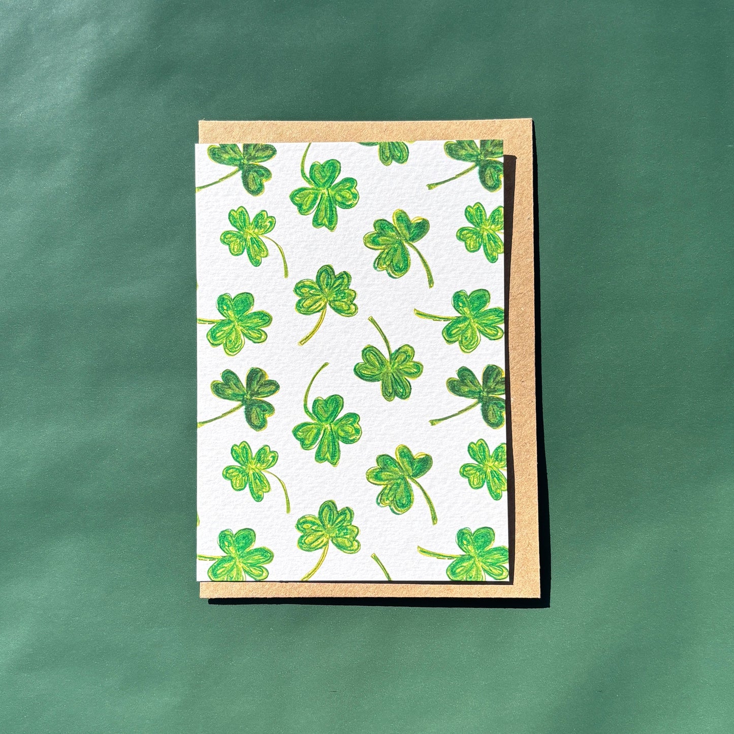 Greeting Card with green shamrock pattern on a textured green background