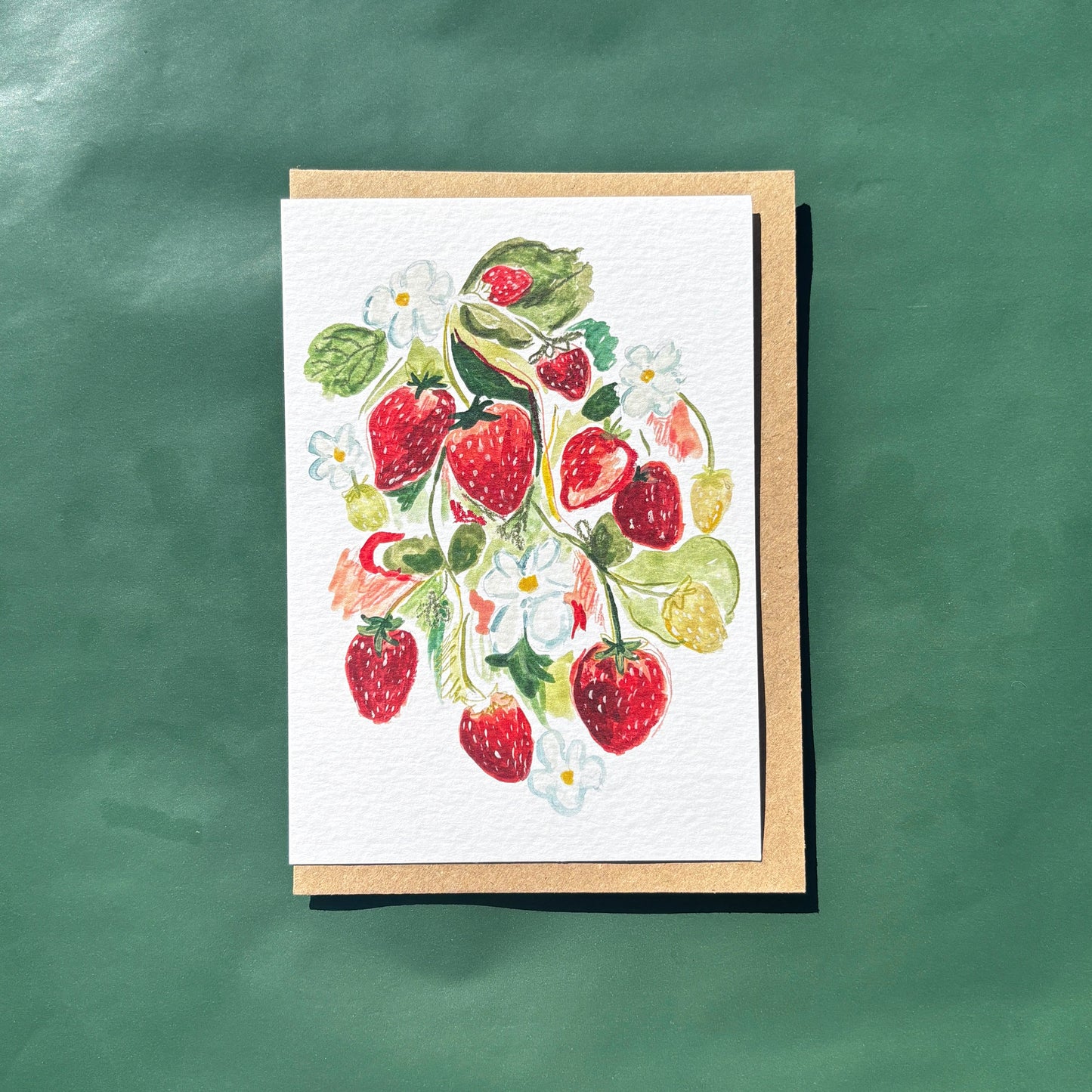 Greeting card with a painting of strawberries and flowers.